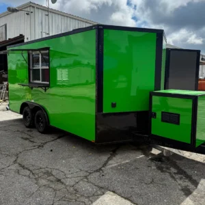 Bright green enclosed dual-axle trailer with serving window and black trim, parked on pavement.