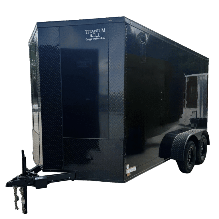Custom black standard enclosed cargo trailer with aluminum trim, parked on paved concrete site.
